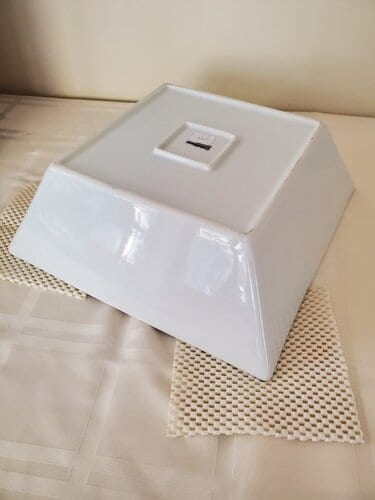 Sturdy serving dish flipped over used to add height to a buffet for entertaining.