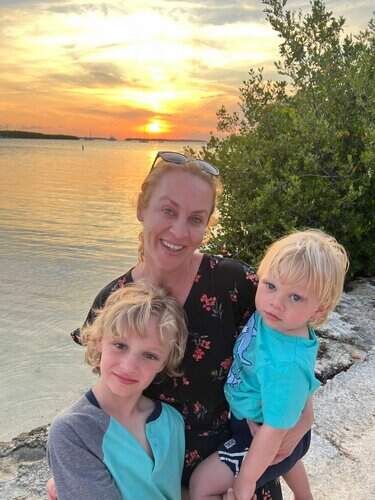 Mother and sons enjoying sunset by the water in Florida Keys